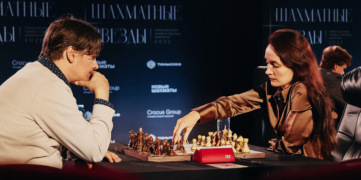Two chess players engaged in an intense match at a tournament table, with clocks and spectators in the background
