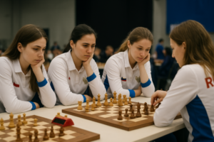 Russian women’s national chess team at the board during a team tournament: four players in national uniforms analyzing a position in a brightly lit playing hall
