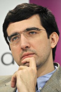 Vladimir Kramnik against the backdrop of a FIDE chess tournament; the atmosphere reflects a serious discussion about anti-doping control in professional chess.