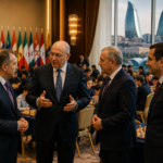 FIDE representatives and organizers talk at an international chess tournament in Baku, with players and the city skyline in the background.