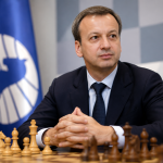 FIDE President Arkady Dvorkovich seated at a chessboard during an official event, symbolizing the leadership of the International Chess Federation and the upcoming presidential election.